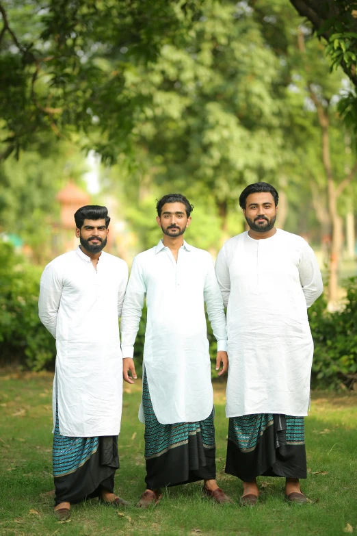 a group of three men standing next to each other, inspired by Thota Vaikuntham, pexels contest winner, hurufiyya, wearing a kurta, wearing white cloths, modelling, bangladesh