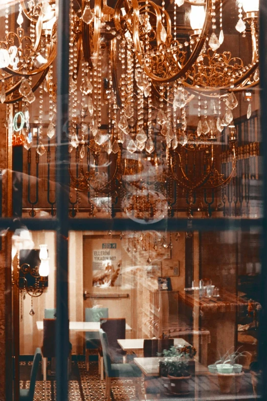 the reflection of a chandelier in a shop window, a digital rendering, inspired by Elsa Bleda, trending on pexels, baroque, golden windows, french village interior, sparkly, taken in the 2000s