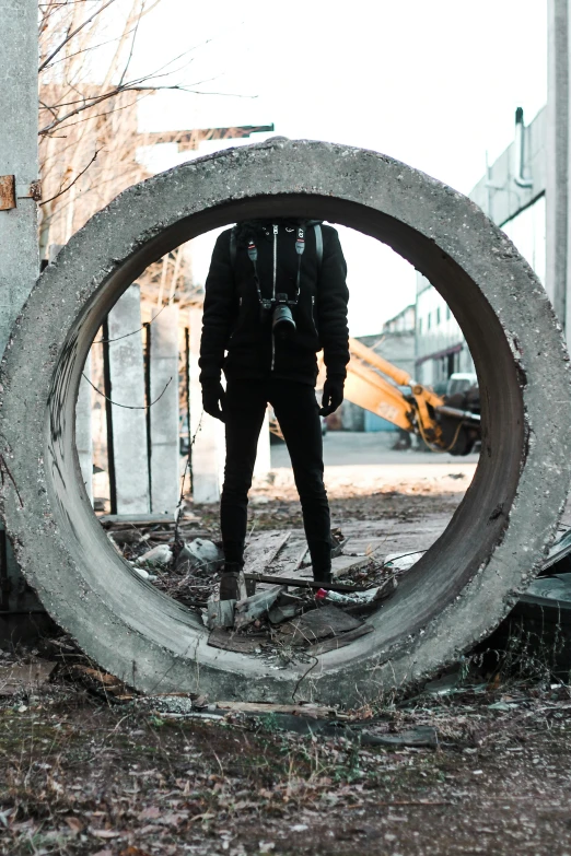 a man standing inside of a concrete ring, an album cover, pexels contest winner, concrete art, techwear clothes, construction, brutalist fashion show, biker