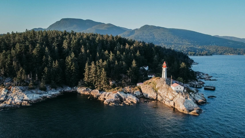 a lighthouse sitting on top of a rocky island, pexels contest winner, vancouver school, aerial, trees and cliffs, thumbnail, multiple stories