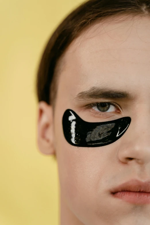 a man with a black eye patch on his face, by Julia Pishtar, trending on pexels, bauhaus, made of smooth black goo, synthetic bio skin, flume, glossy