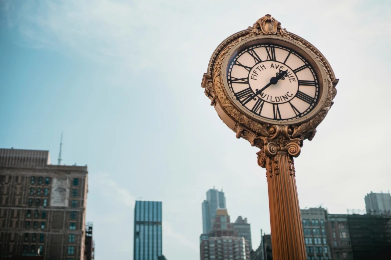 a clock on a pole in the middle of a city, by Greg Rutkowski, unsplash, art nouveau, square, new york times, background image