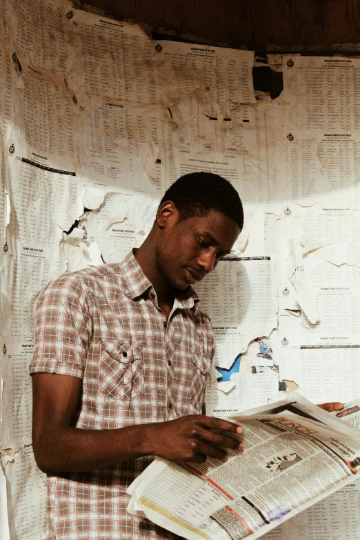 a man reading a newspaper in a room, by Ellen Gallagher, happening, somalia, post graduate, handsome, mechanics