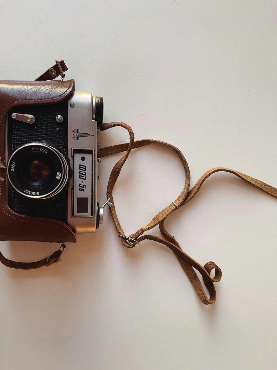 a brown camera sitting on top of a white table, by Sven Erixson, cinematic. by leng jun, ( dieter rams ), ecommerce photograph