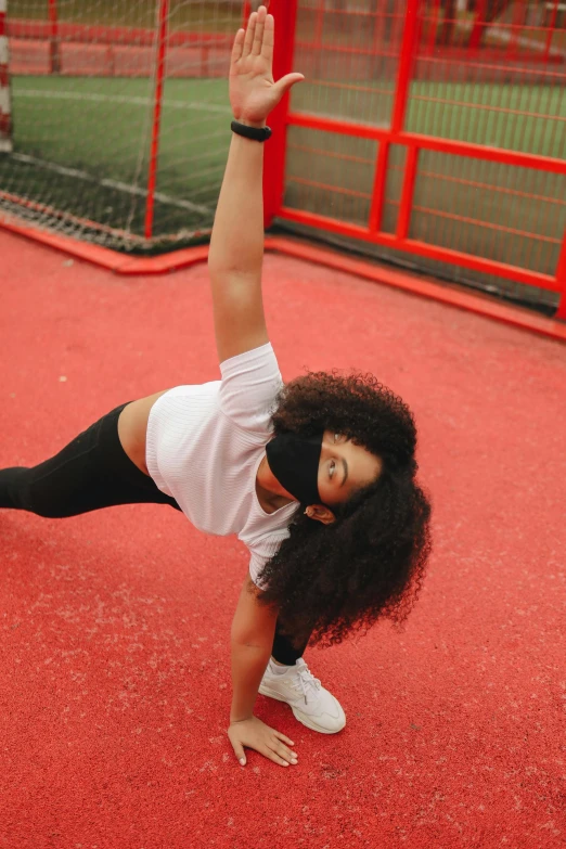 a woman doing a handstand on a tennis court, pexels contest winner, arabesque, with afro, white and red body armor, black haired girl wearing hoodie, taken in 2022