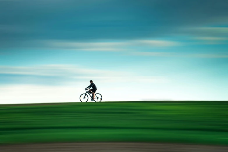 a man riding a bike across a lush green field, inspired by Chris Friel, minimalism, shot with hasselblad, blue sky, ilustration, peter guthrie