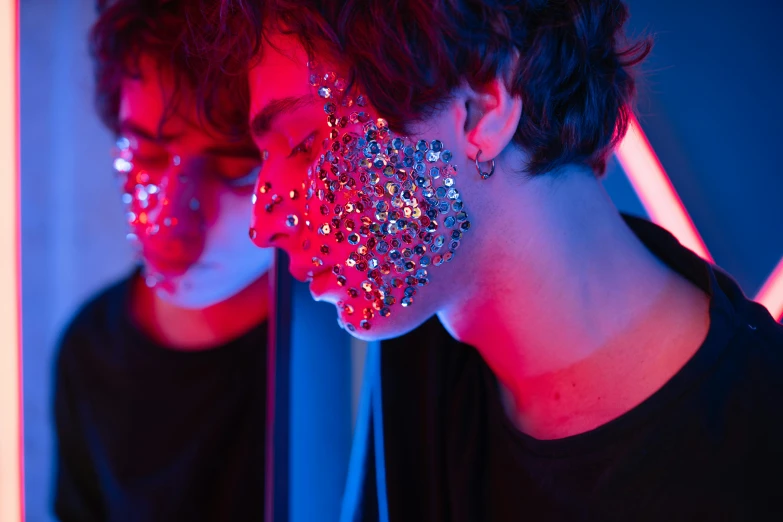 a woman with glitter on her face in front of a mirror, an album cover, trending on pexels, holography, red and blue neon, 1 7 - year - old boy thin face, covered in circuitry, unsplash contest winning photo