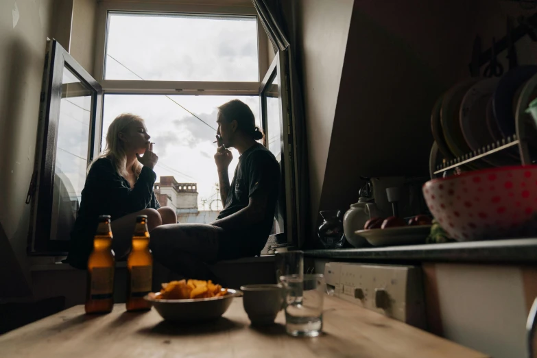 a couple of women sitting in a kitchen next to a window, by Jan Tengnagel, pexels, realism, beer, man, rooftop romantic, profile image