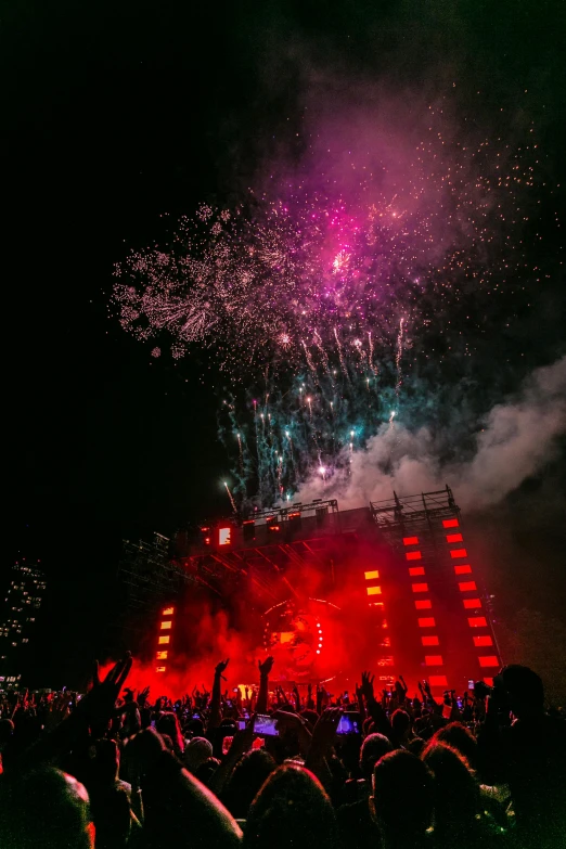 a crowd of people watching fireworks in the sky, giant red led screens, wild rave outfit, firing it into a building, profile image