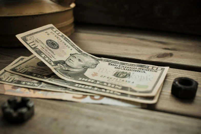 a pile of money sitting on top of a wooden table, vintage vibe, thumbnail, fan favorite, highresolution