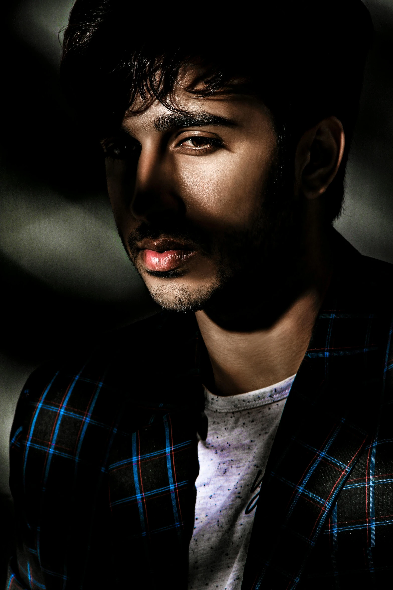 a close up of a person wearing a jacket, inspired by Adam Dario Keel, trending on pexels, farid ghanbari, lips, portrait pose, high contrast dappled lighting