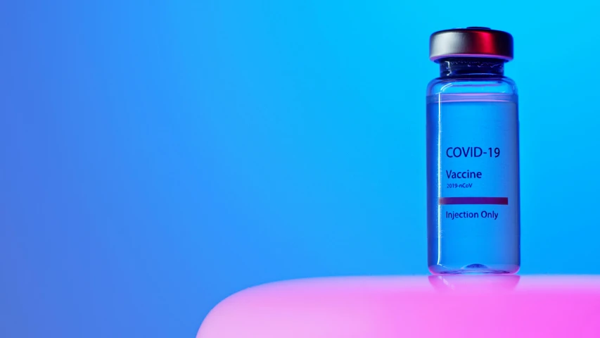 a bottle of liquid sitting on top of a table, pink and blue gradients, holding syringe, beauty is a virus, cover corp