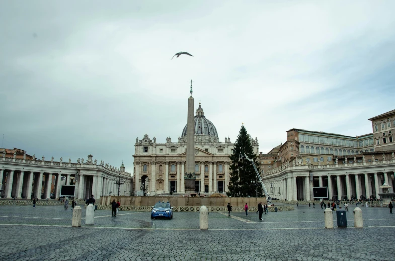 a car is parked in front of a large building, by Cagnaccio di San Pietro, pexels contest winner, neoclassicism, kneeling before the pope, square, panoramic, doves