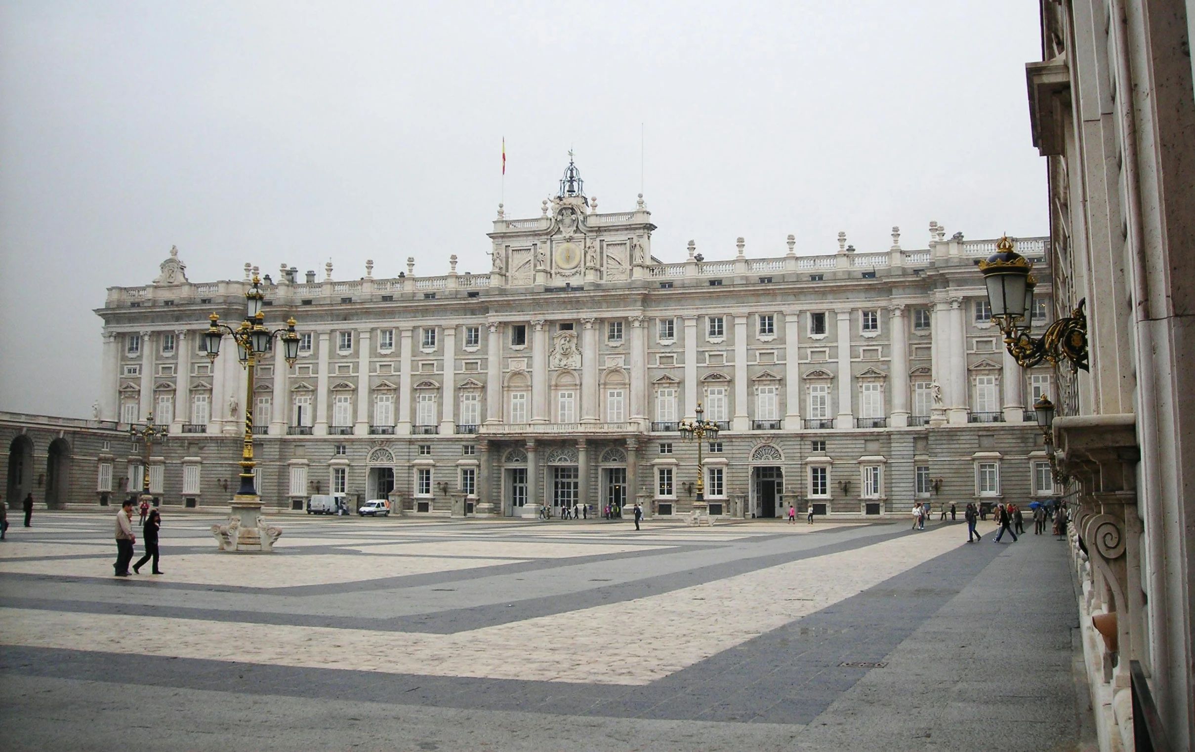 a large building with a clock on the front of it, a marble sculpture, by Pablo Rey, neoclassicism, coronation, diego velazquez, 🦩🪐🐞👩🏻🦳, ground - level view