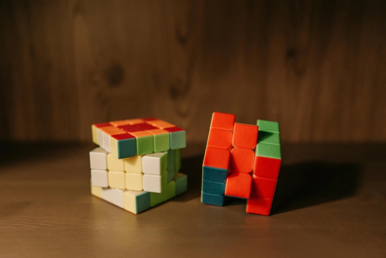 a couple of rubik cubes sitting on top of a wooden table