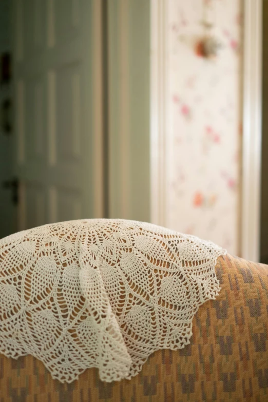 a close up of a chair with a doily on it, net art, hotel room, back towards camera, sitting on a sofa, head shoot