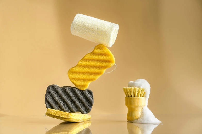 a couple of toothbrushes sitting on top of a table, yellow charcoal, intricate pasta waves, sponge, product design shot