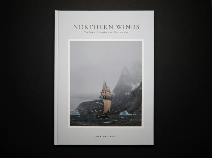 a black and white photo of a ship in the ocean, an album cover, by Jesper Knudsen, art nouveau, wind turbines, flatlay book collection, northern lights, hard cover book