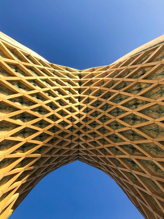 a wooden structure with a blue sky in the background, by Jason Felix, pexels contest winner, renaissance, tehran, cone shaped, tall golden heavenly gates, iphone photo