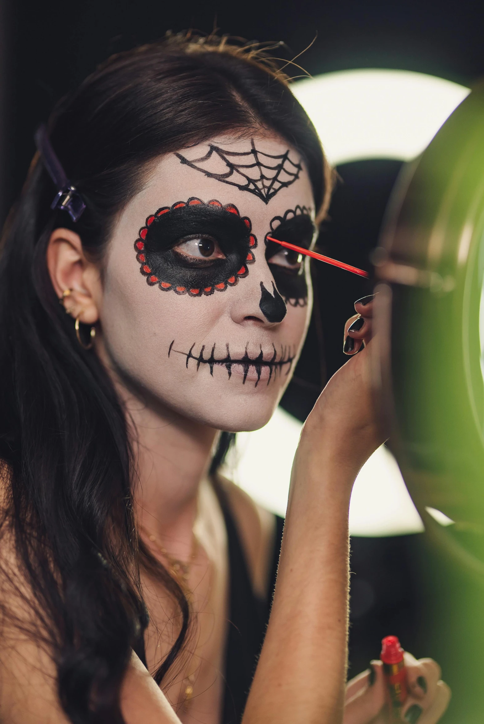 a woman is putting make up on her face, a cartoon, pexels contest winner, lowbrow, skull face paint, promo image, profile image, mexican