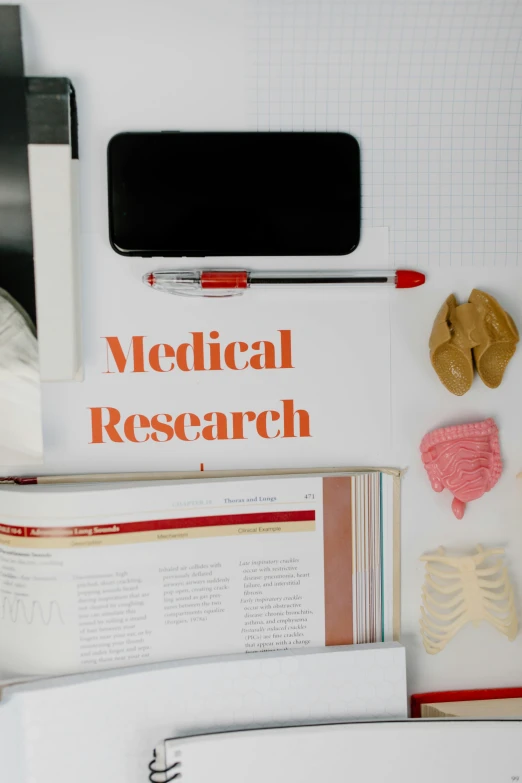 a laptop computer sitting on top of a pile of books, a poster, by Rachel Reckitt, trending on pexels, medical dissection, with a stethoscope, science journal cover, thumbnail