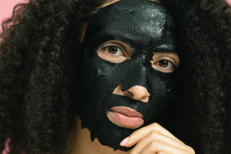 a woman with a black mask on her face, trending on pexels, textured base ; product photos, panel of black, manuka, black-hair pretty face