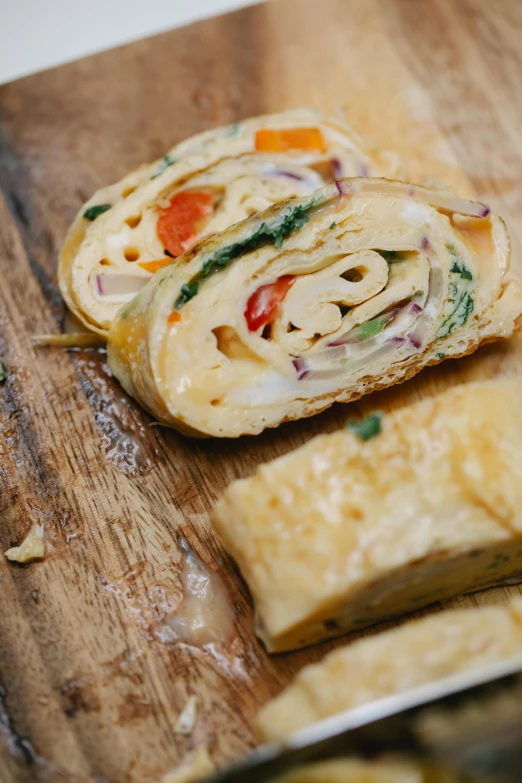 a wooden cutting board with some food on it, epicanthal fold, creamy, multiple stories, fujifilm”