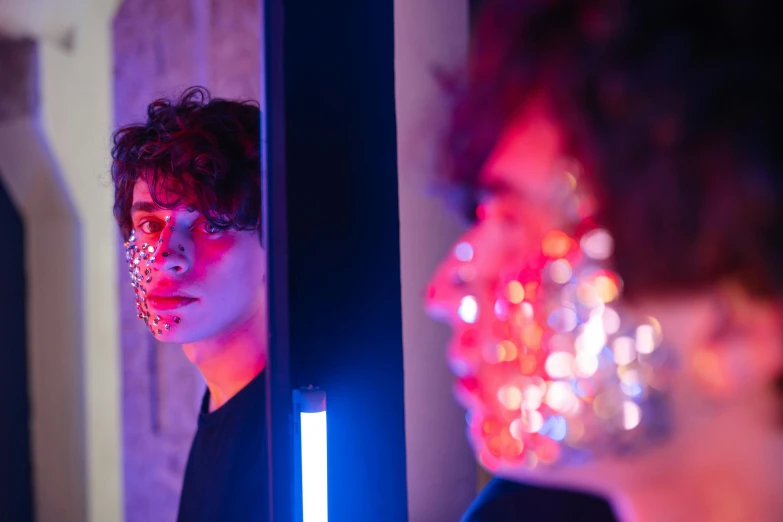 a man that is standing in front of a mirror, pexels contest winner, serial art, skin made of led point lights, declan mckenna, blue and red lights, robert sheehan