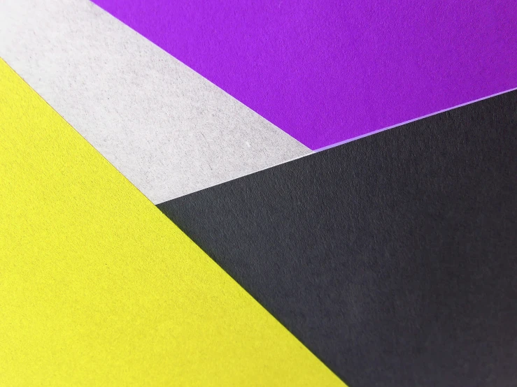 a close up of a piece of paper with different colors, inspired by Frederick Hammersley, unsplash, geometric abstract art, black and purple, yellow purple, origami studio 3 design, random metallic colors