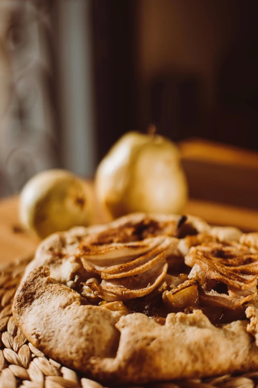 a pizza sitting on top of a wooden table, a still life, trending on pexels, renaissance, pear, crisp detail, cake, molten