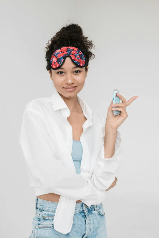 a woman in a white shirt holding a cell phone, toothpaste refinery, floral patterned skin, red and blue garments, skincare