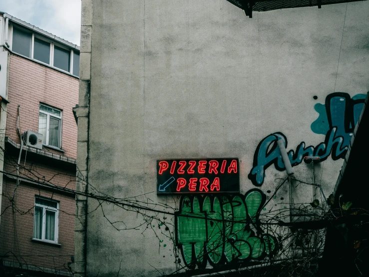 a sign that is on the side of a building, inspired by Elsa Bleda, pexels contest winner, graffiti, pizza, jovana rikalo, 90's photo