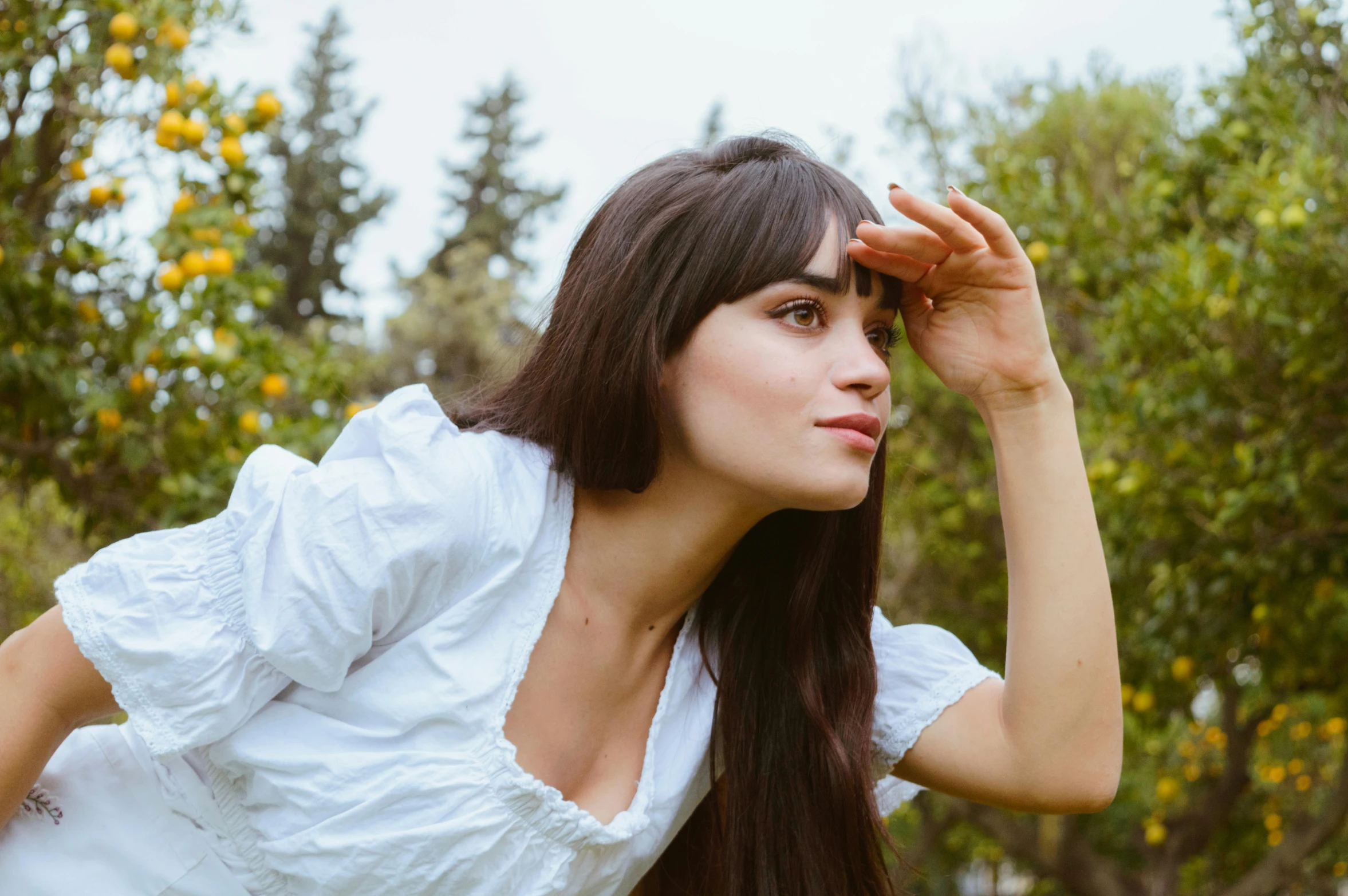 a beautiful woman laying on top of a lush green field, by irakli nadar, pexels contest winner, photorealism, blunt bangs fall on her forehead, a beautiful woman in white, female camila mendes, profile image