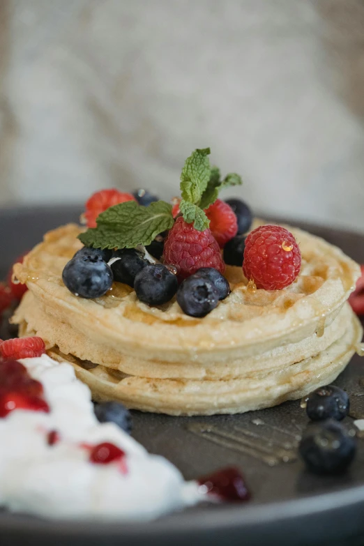 a plate of waffles topped with berries and whipped cream, a still life, unsplash, blonde crea, eco, headshot, background image