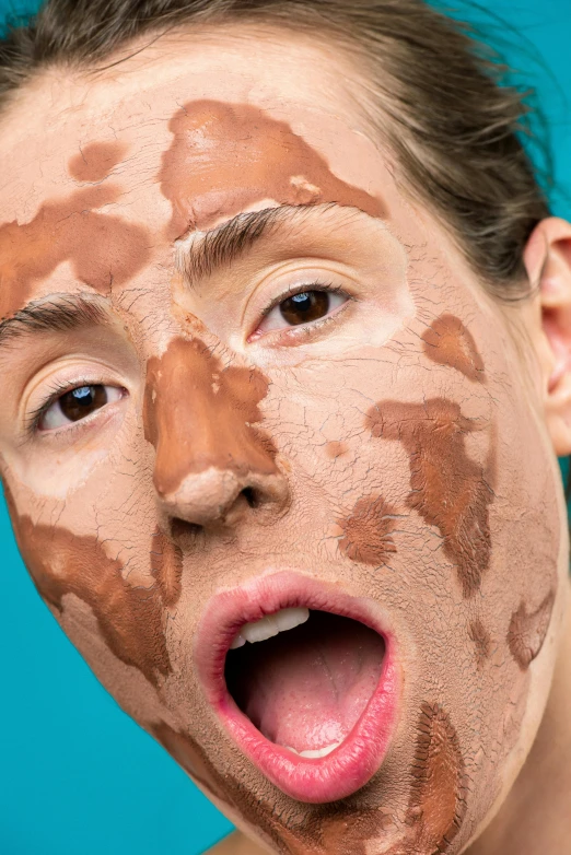 a close up of a person with mud on their face, an album cover, by Ellen Gallagher, trending on pexels, silly face, brown, skincare, lush