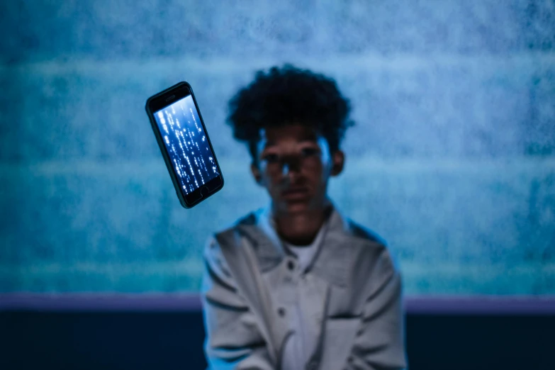 a close up of a person holding a cell phone, by James Morris, conceptual art, ashteroth, suspended in zero gravity, teenage engineering moad, portrait 8 k
