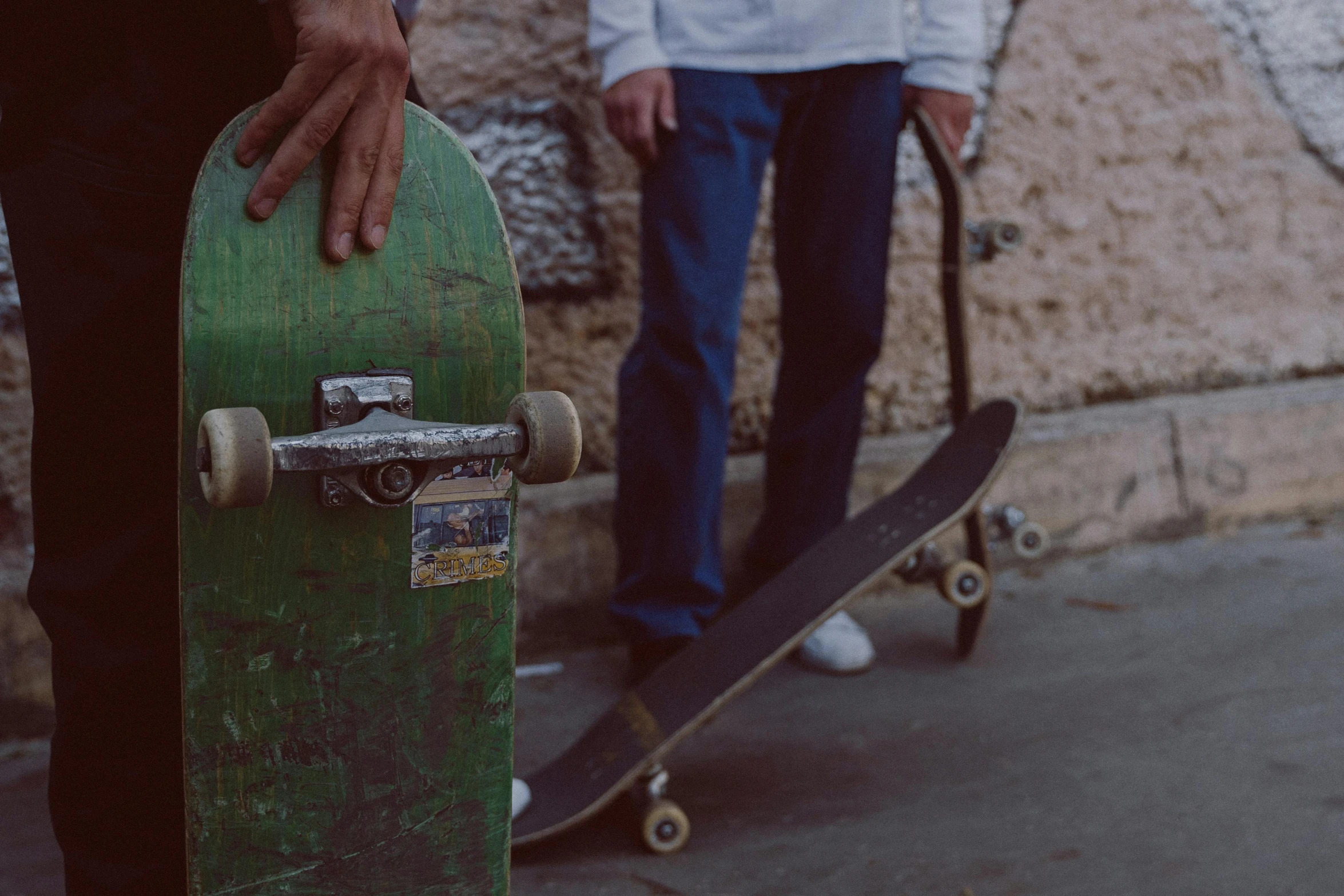 a person standing next to a skateboard on a sidewalk, pexels contest winner, a green, bench, faded worn, medium shot of two characters