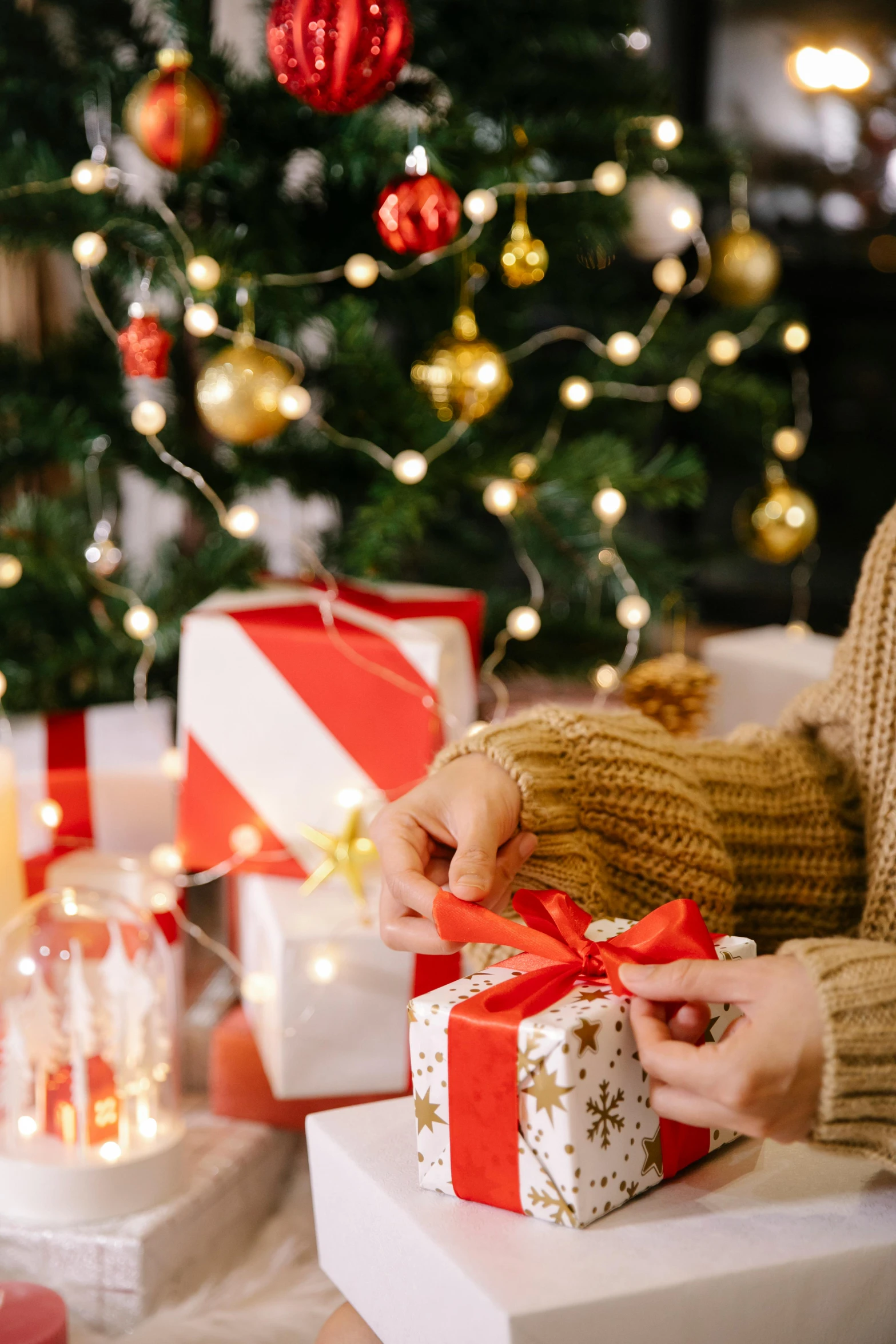 a woman opening a christmas present in front of a christmas tree, by Julia Pishtar, happening, bows, middle close up composition, promo image, fully decorated