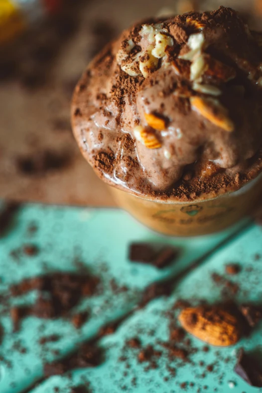 a close up of a cup of chocolate ice cream, a portrait, trending on pexels, seeds, vanilla smoothie explosion, thumbnail, 2654465279