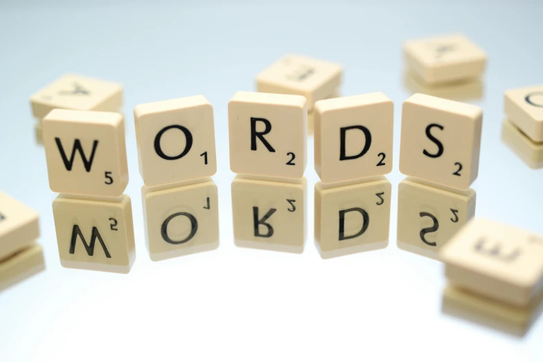 a number of wooden blocks with words on them, shortsword, on a pale background, reading, vocal