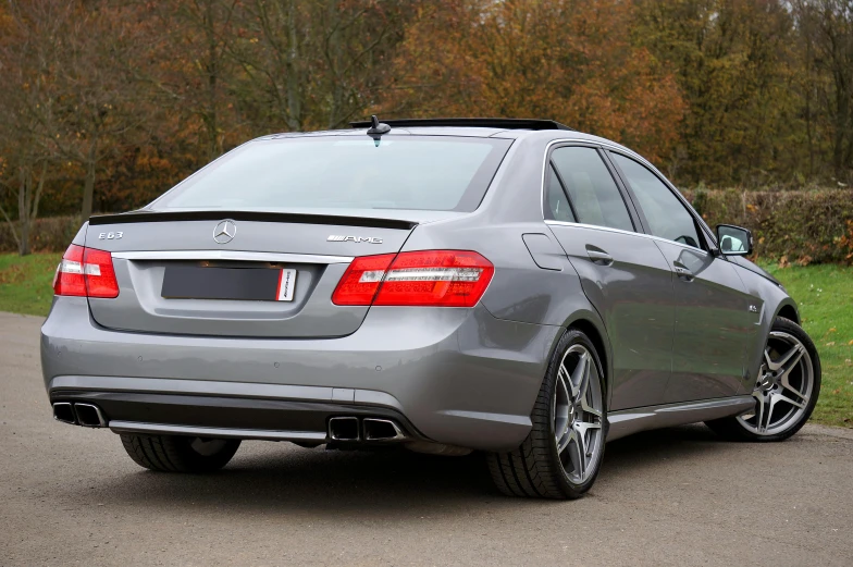 a silver car parked on the side of a road, rear facing, gun metal grey, aftermarket parts, 2263539546]