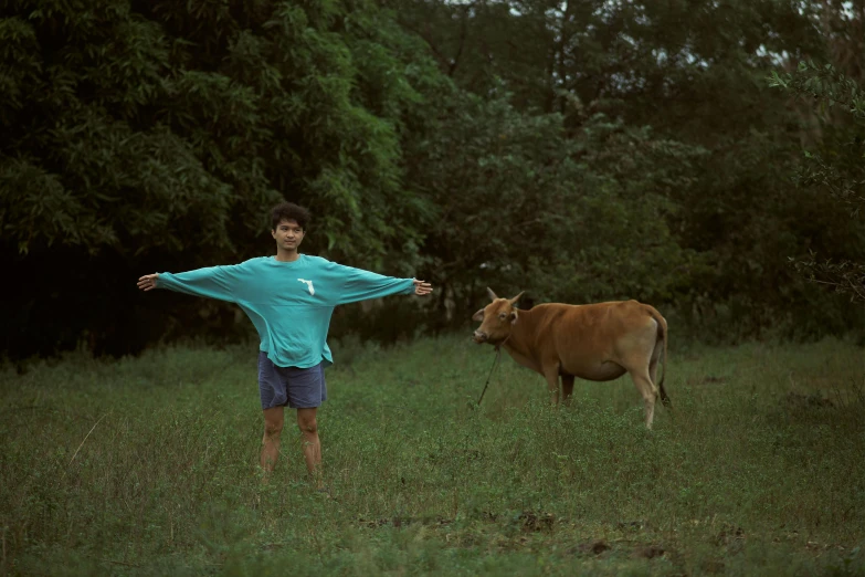 a boy standing in a field with a cow, pexels contest winner, conceptual art, in style of thawan duchanee, t pose, dolman, medium format