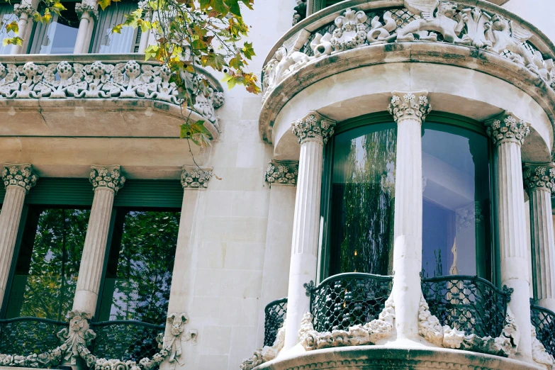 a large white building with many windows and balconies, inspired by Tomàs Barceló, pexels contest winner, art nouveau, carved marble, window view, lush surroundings, instagram post