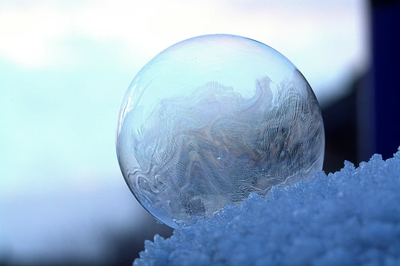 a bubble sitting on top of a pile of snow, pexels contest winner, blue marble, frosted glass, ripple, icicle