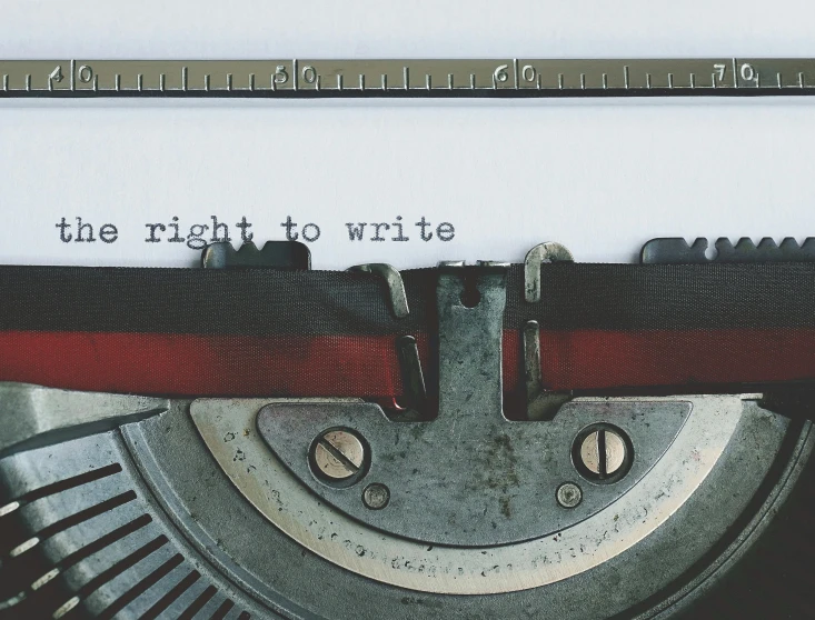 a typewriter with the words the right to write, an album cover, by Kurt Roesch, unsplash, fan favorite, concrete poetry, ethics, half image