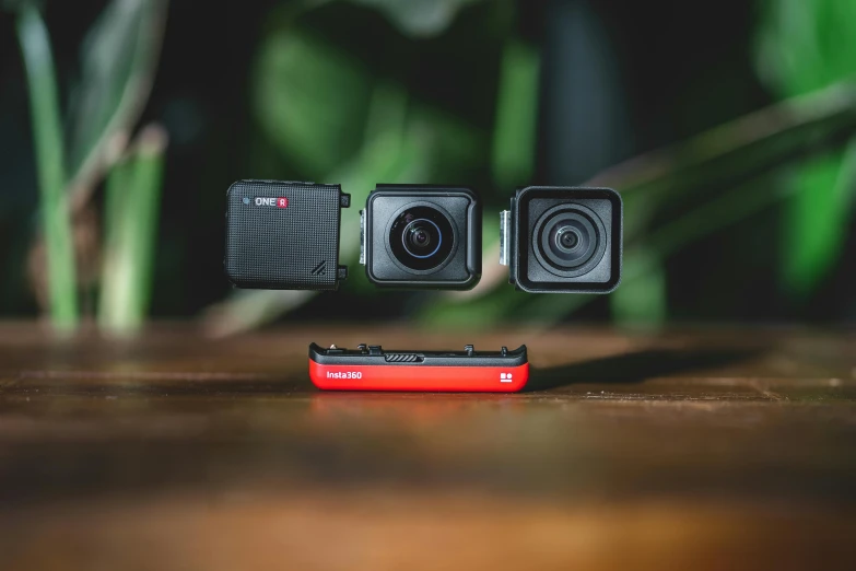 a camera sitting on top of a wooden table, a picture, black and red colour palette, products shot, thumbnail, switch