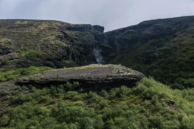 a group of people standing on top of a lush green hillside, by Hallsteinn Sigurðsson, hurufiyya, waterfall in asteroid field, rock roof, background image