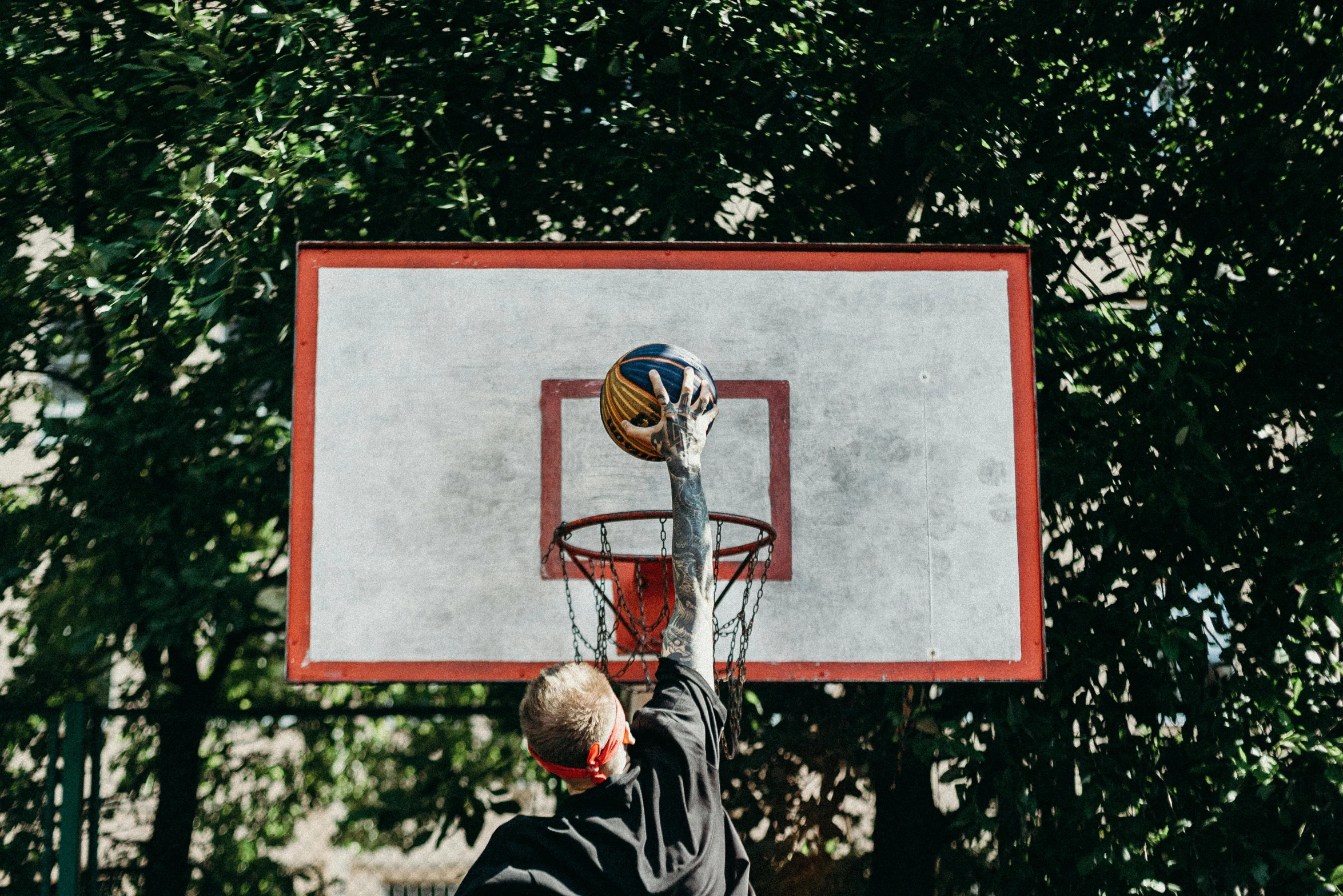 a man standing on top of a basketball court holding a basketball, by Joe Bowler, pexels contest winner, dunking, 15081959 21121991 01012000 4k, zoomed in, backyard