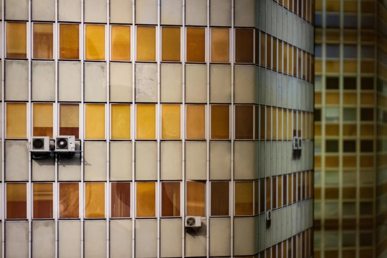 a white toilet sitting in a bathroom next to a tiled wall, a mosaic, inspired by Andreas Gursky, unsplash, bauhaus, rusty metal towers, colorful glass wall, behind bars, muted brown yellow and blacks