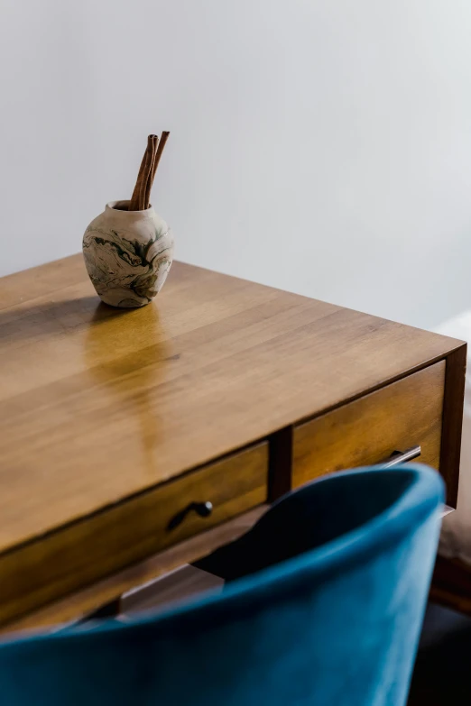 a wooden desk with a blue chair next to it, wood cups, cleanest image, sparse detail, colombian